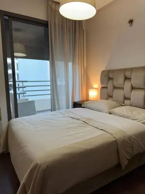 a bedroom with a large bed and a window at Stylish 2 bedroom, in the heart of Casablanca in Casablanca