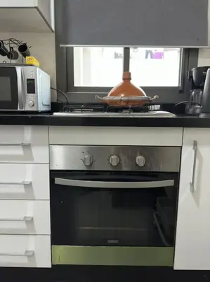 a kitchen with a stove and a microwave at Stylish 2 bedroom, in the heart of Casablanca in Casablanca