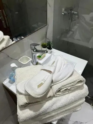a bathroom with white towels on a sink at Stylish 2 bedroom, in the heart of Casablanca in Casablanca