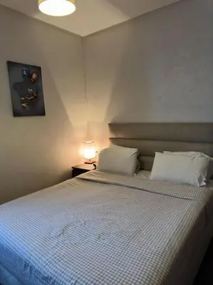 a bedroom with a large bed with two pillows at Stylish 2 bedroom, in the heart of Casablanca in Casablanca