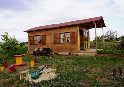 a small log cabin with a table and a playground at Countryside's Tiny House in O Ben Slimane