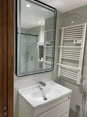 a bathroom with a white sink and a mirror at Rock Island Haut standing in Mohammedia