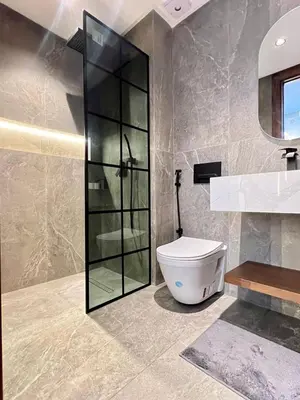 a bathroom with a toilet and a glass shower at Studio prague in Casablanca