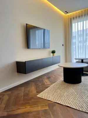 a room with a table and a tv on a wall at Studio prague in Casablanca