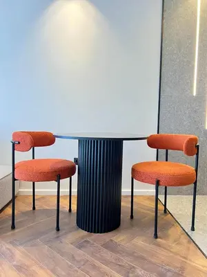 two orange chairs sitting next to a table at Studio prague in Casablanca