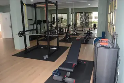 a gym with a row of treadmills and machines at Apparemment Meuble a 5 min de l'aéroport casa in Nouaceur
