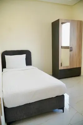 a bedroom with a bed with a mirror and a window at Les portes de Temara in Temara
