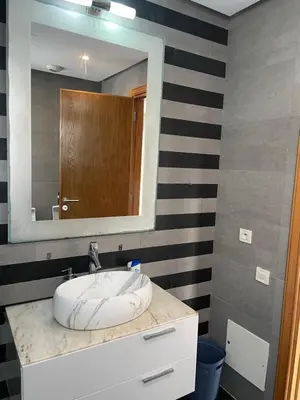 a bathroom with a sink and a mirror at Charming Seaview Apartment 4 in Casablanca