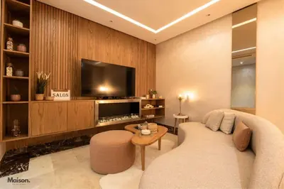 a living room with a couch and a flat screen tv at Luxury Suite Mannesmann - Seaview in Mohammedia