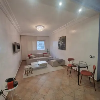 a living room with a couch and a table at Appartement lumineux by Moon in Casablanca