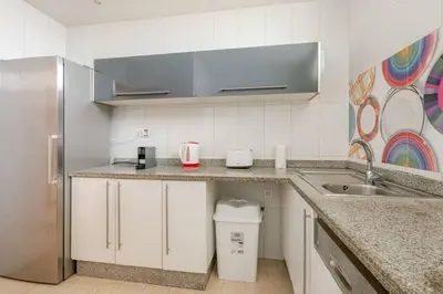 a kitchen with a sink and a refrigerator at Beachfront Escape - Panoramic View and Spacious Terrace in Skhirat