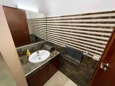 a bathroom with a sink and a mirror at Spacious & Comfy Moroccan Apartment in Temara