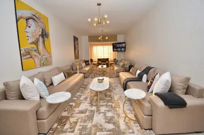 a large living room with couches and a table at Spacious Haven in Abdelmoumen in Casablanca