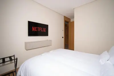 a bedroom with a white bed and a sign on the wall at Luxury Studio in Luxury Place in Casablanca
