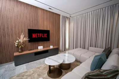 a living room with a couch and a tv at Luxury Studio in Luxury Place in Casablanca