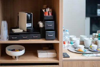 a cupboard with a coffee maker and cups on it at Luxury Studio in Luxury Place in Casablanca