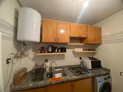 a small kitchen with a sink and a microwave at Un écrin rabati in Rabat