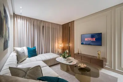 a living room with a white couch and a tv at Beautiful 1 Bedroom Appartment in Anfa in Casablanca