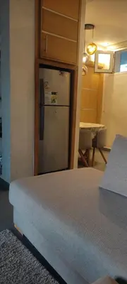 a kitchen with a stainless steel refrigerator in a room at Les perles de Tamaris in Dar Mohammed Ould Haj Jilali