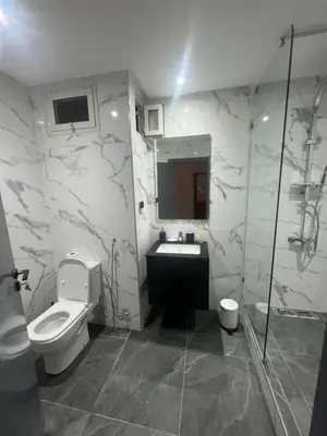 a bathroom with a toilet and a sink and a shower at Superb appartement au centre ville in Rabat