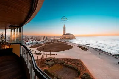 a view of the beach from the balcony of a building at Royal Senior Suite 3Bd & 3Ba -By Appart Ayla in Casablanca-Port