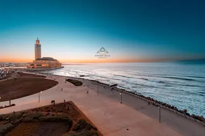 a view of the ocean and a beach at sunset at Royal Senior Suite 3Bd & 3Ba -By Appart Ayla in Casablanca-Port