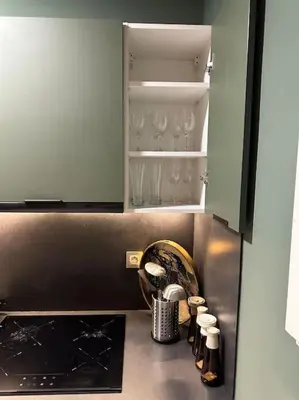 a kitchen counter with wine glasses in a cabinet at Studio luxueux bien meublé in Casablanca