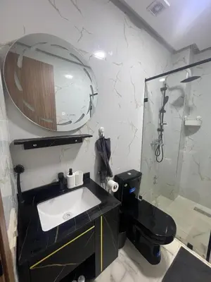 a bathroom with a black sink and a mirror at Bel appartement à louer sur bouznika de 117 m2 in Bouznika