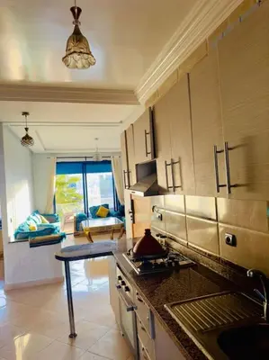 a kitchen with a sink and a counter top at Bel Appartement vue piscine in Mansouria