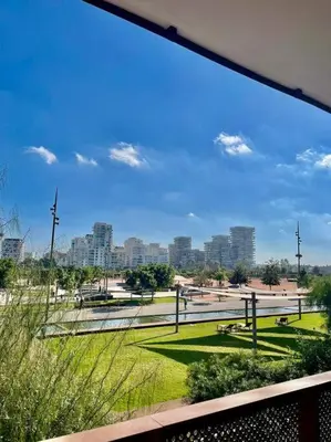 a view of a park with a city in the background at Vue imprenable sur Casa Finance City in Casablanca