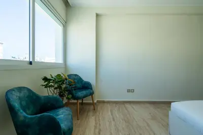 two blue chairs and a plant in a room at Appartement à Maarif, Proche du Twin et McDonald's in Casablanca
