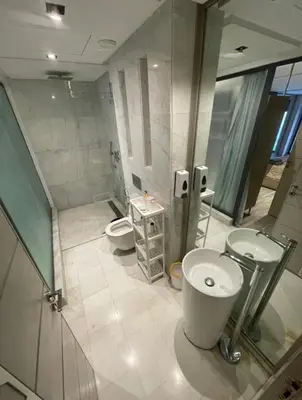 a bathroom with two toilets and two sinks and a shower at Estay in Casablanca