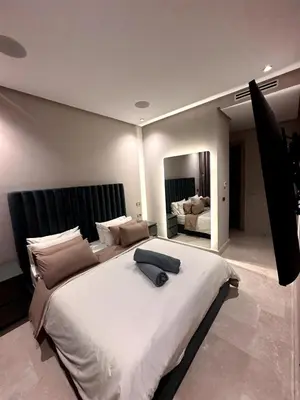 a large white bed in a bedroom with a mirror at Skyline Albert Luxury 2 a proximité de la gare Casa voyageurs Casablanca in Casablanca