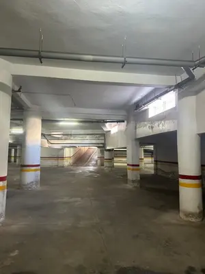 an empty parking garage with columns and a parking lot at Appartement corniche d'or, Mohammedia in Mohammedia