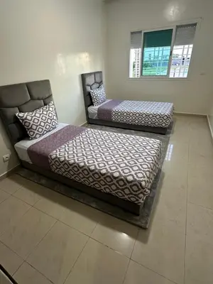 two beds sitting next to each other in a room at Appartement corniche d'or, Mohammedia in Mohammedia