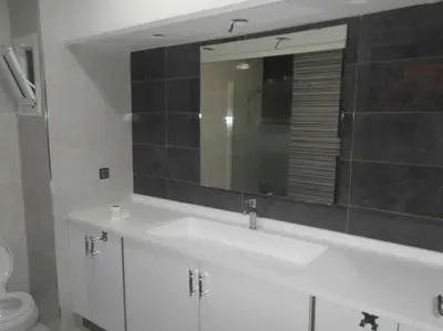 a bathroom with a white sink and a mirror at Spacious apartment in Rabat Agdal 1937,5 ft2 - 180m2 in Rabat
