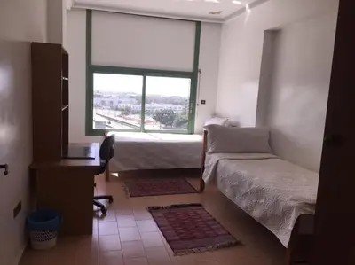 a bedroom with a bed and a window and a desk at Spacious apartment in Rabat Agdal 1937,5 ft2 - 180m2 in Rabat