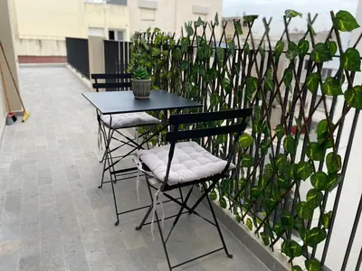 a table and two chairs next to a fence at Golden Spot Casablanca in Casablanca