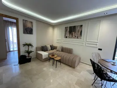 a living room with a couch and a table at Golden Spot Casablanca in Casablanca
