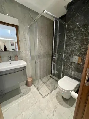 a bathroom with a shower and a toilet and a sink at Golden Spot Casablanca in Casablanca