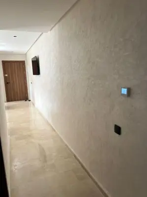 a hallway with a white wall and a door at Appartement - EL Mansouria - Mohammadia - Bouznika in Mansouria