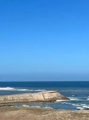 a group of rocks in the ocean on a beach at Appartement - EL Mansouria - Mohammadia - Bouznika in Mansouria