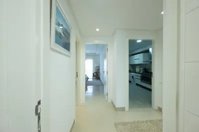 a white hallway with a kitchen in a house at Ocean Pearl - Exclusive 2BR Oceanfront Luxury & Views in Bouznika