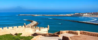 a castle next to the ocean and a beach at Studio l'Escale D'Agdal in Rabat