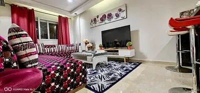 a living room with a couch and a tv at Turner Vision in Casablanca
