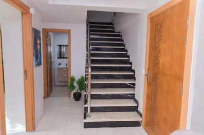 a spiral staircase with black treads in a hallway at Cozy Duplex appartement wifi parking proximité in Rabat