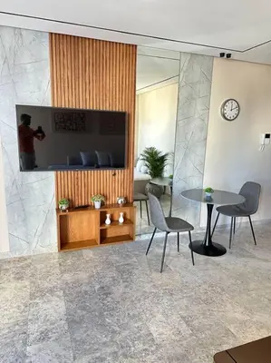 a room with a table and chairs and a tv at Studio Monaco in Casablanca