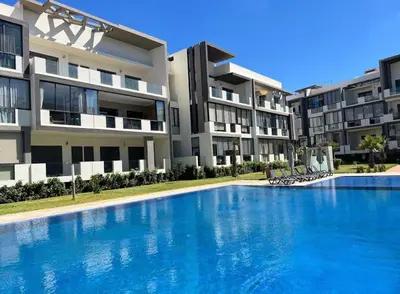 a large swimming pool in front of a building at les crêtes dar bouazza in Tamaris