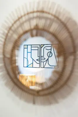 a circular mirror with a drawing of a person at Prestigia Luxe Suite by MERAT HOME in Rabat