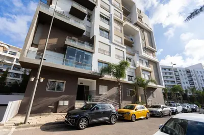 a group of cars parked in front of a building at Prestigia Luxe Suite by MERAT HOME in Rabat
